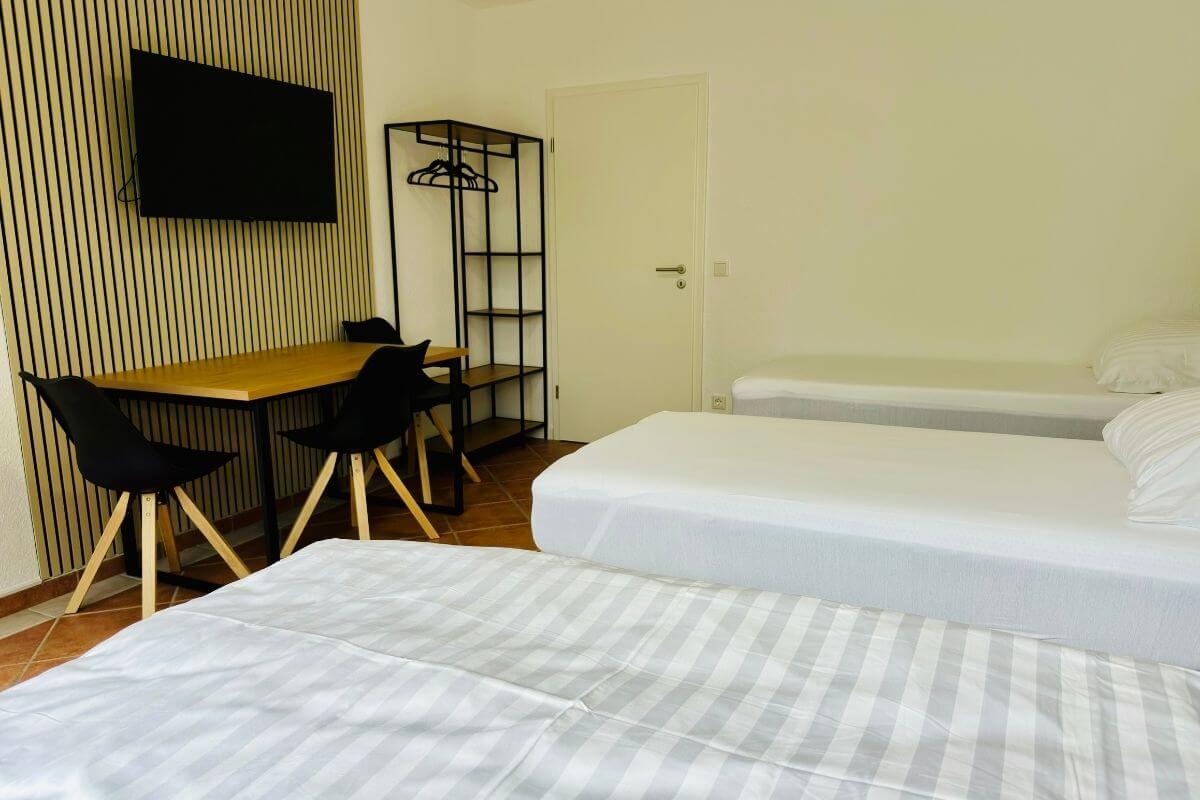 rg-living-herford-zweibettzimmer-mit-tv-und-regal-monteure-teams